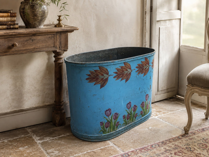 Side view of French blue painted zinc-lined jardiniere with floral decoration