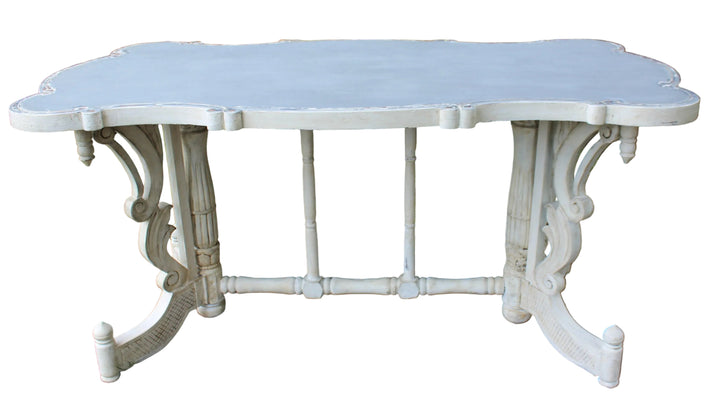 vintage-style painted table with a scalloped top and ornate legs
