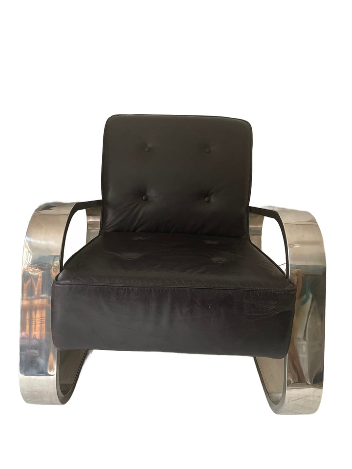 vintage mid century Modern black leather armchair with metallic frame on a white background