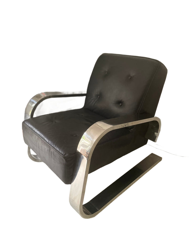 Vintage Mid century Modern black leather chair with chrome metal frame on a white background